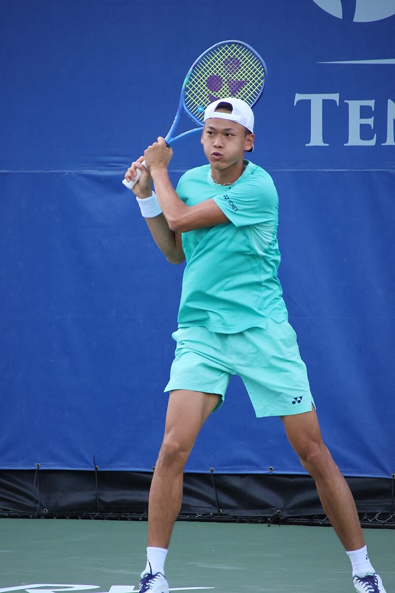 Foto de archivo: Rei Sakamoto, con gorra blanca puesta al revés y conjunto verde agua, prepara un golpe a dos manos frente a una lona azul, en un torneo de 2026 en Cary, Estados Unidos