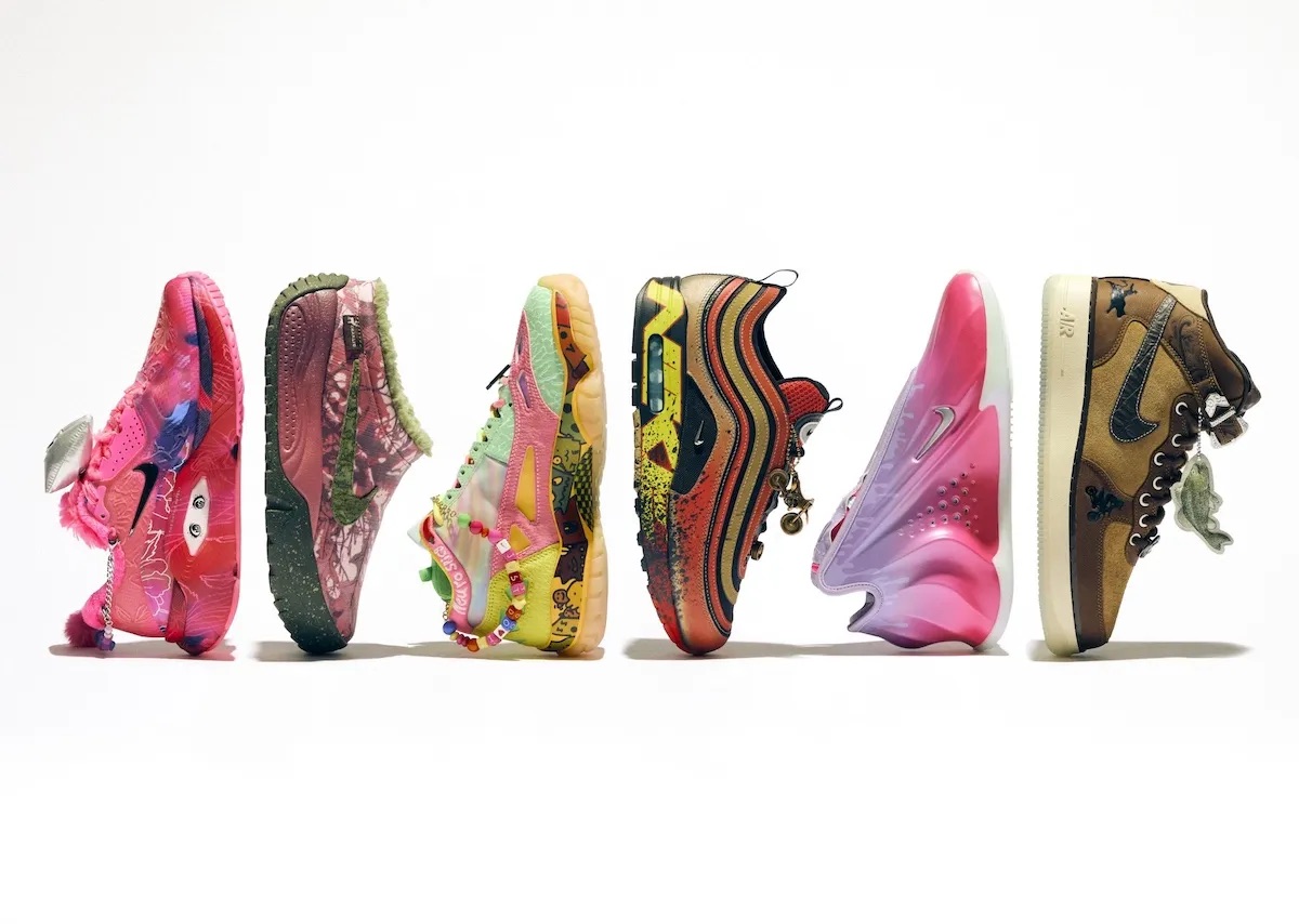 Los seis pares de la colección Nike Doernbecher Freestyle 22 en fila sobre fondo blanco, cada uno con colores, dibujos y colgantes propios: uno rosa con ojos, uno verde y bordó, uno verde agua y rosa, un Air Max 1/97 rojo y dorado, uno rosa y lila, y un Air Force 1 Mid marrón